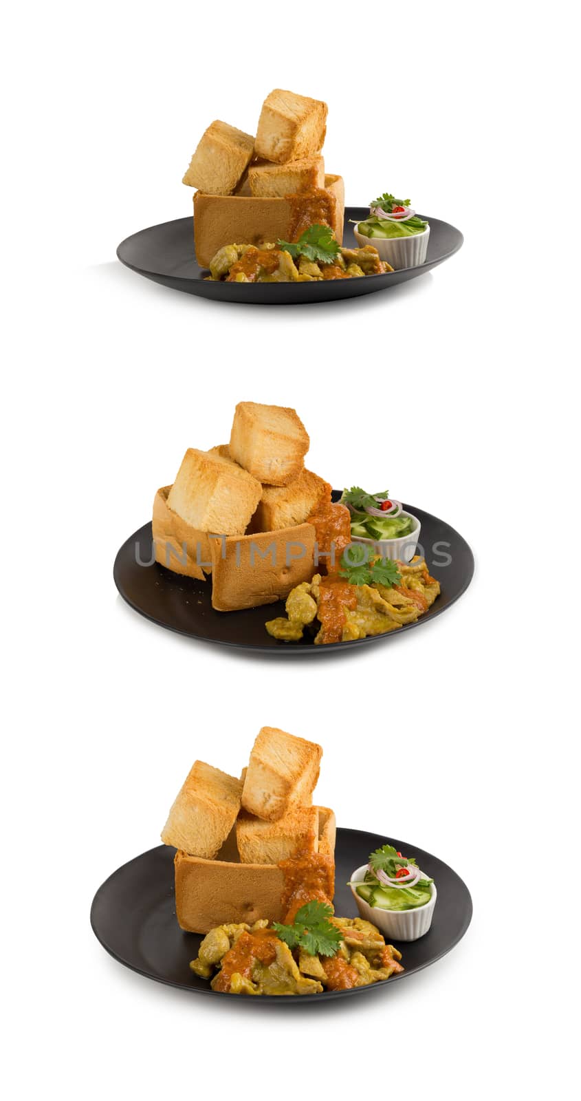 Pork satays with peanut sauce and pickles which are cucumber slices and onions in vinegar served with toast. isolated on white.
