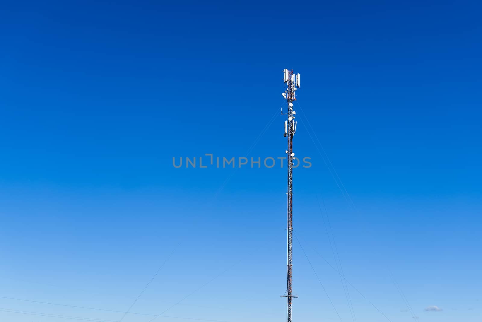 Telecommunication tower of 4G and 5G cellular. Cell Site Base Station. Wireless Communication Antenna Transmitter. Telecommunication tower with antennas against blue sky background. by PhotoTime