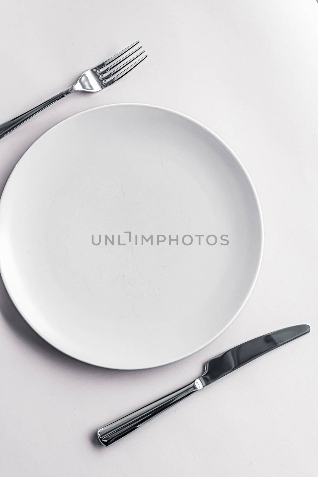 Empty plate and cutlery as mockup set on white background, top tableware for chef table decor and menu branding design