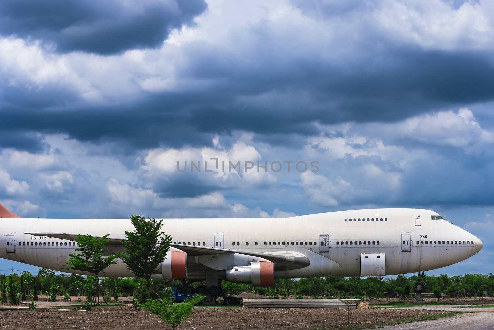 Nakhon Pathom, Thailand - June, 09, 2020 : The old commercial aircraft was discharged with a stormy sky at Nakhon Pathom, Thailand