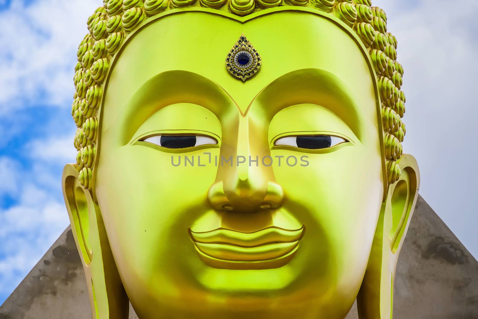 The face of Big Goldden Buddha statue of Chareon Rat Bamrung Temple (Nong Phong Nok Temple) the place of faith in Thailand