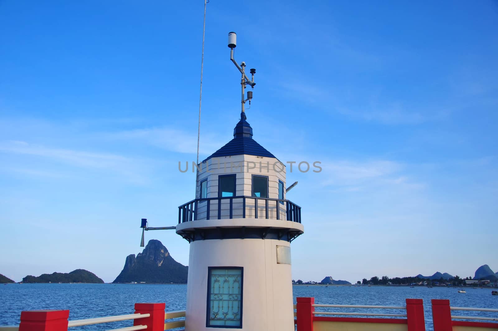 White lighthouse With sea and islands in the background