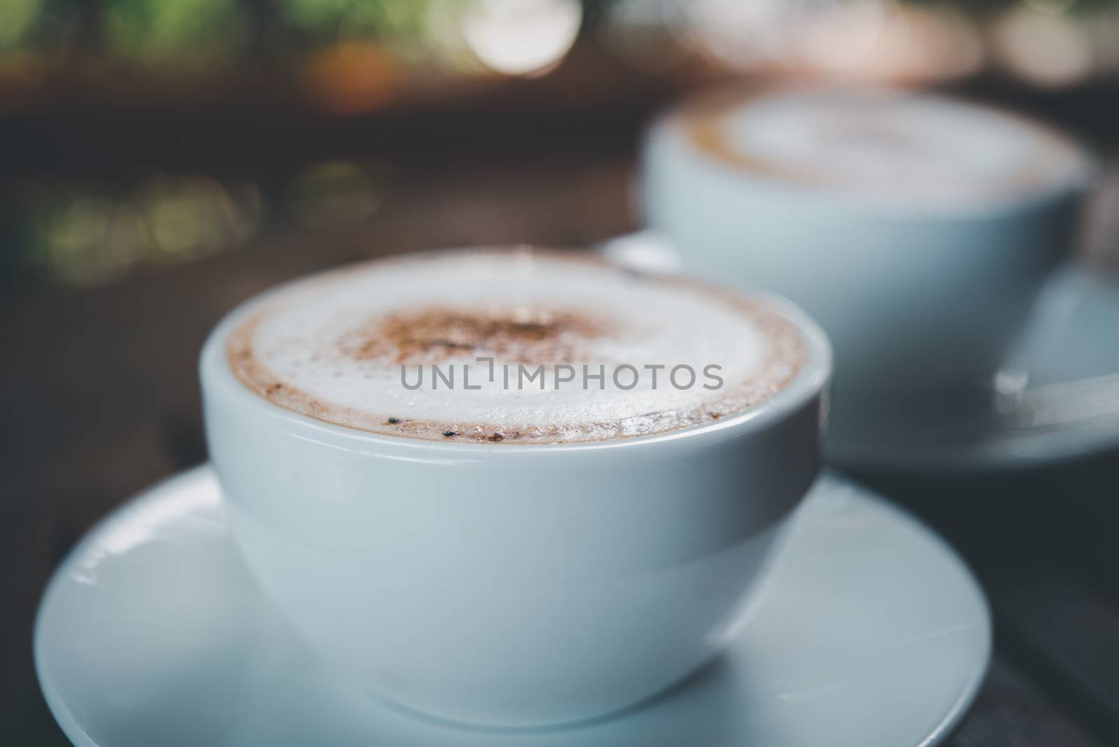Coffee in white cup on table at coffee shop by PongMoji