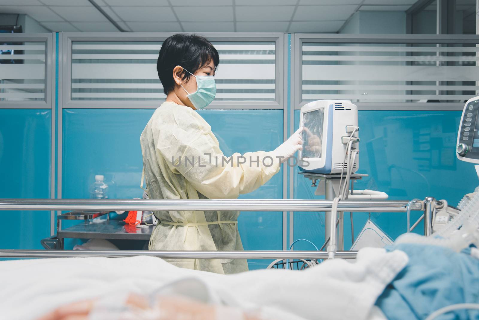 Doctor use monitor with vital signs for medical care of the flu covid19, corona virus, CRE. or VRE. infected elder patient 80s years old on patient bed in intensive care unit (ICU.) room at hospital