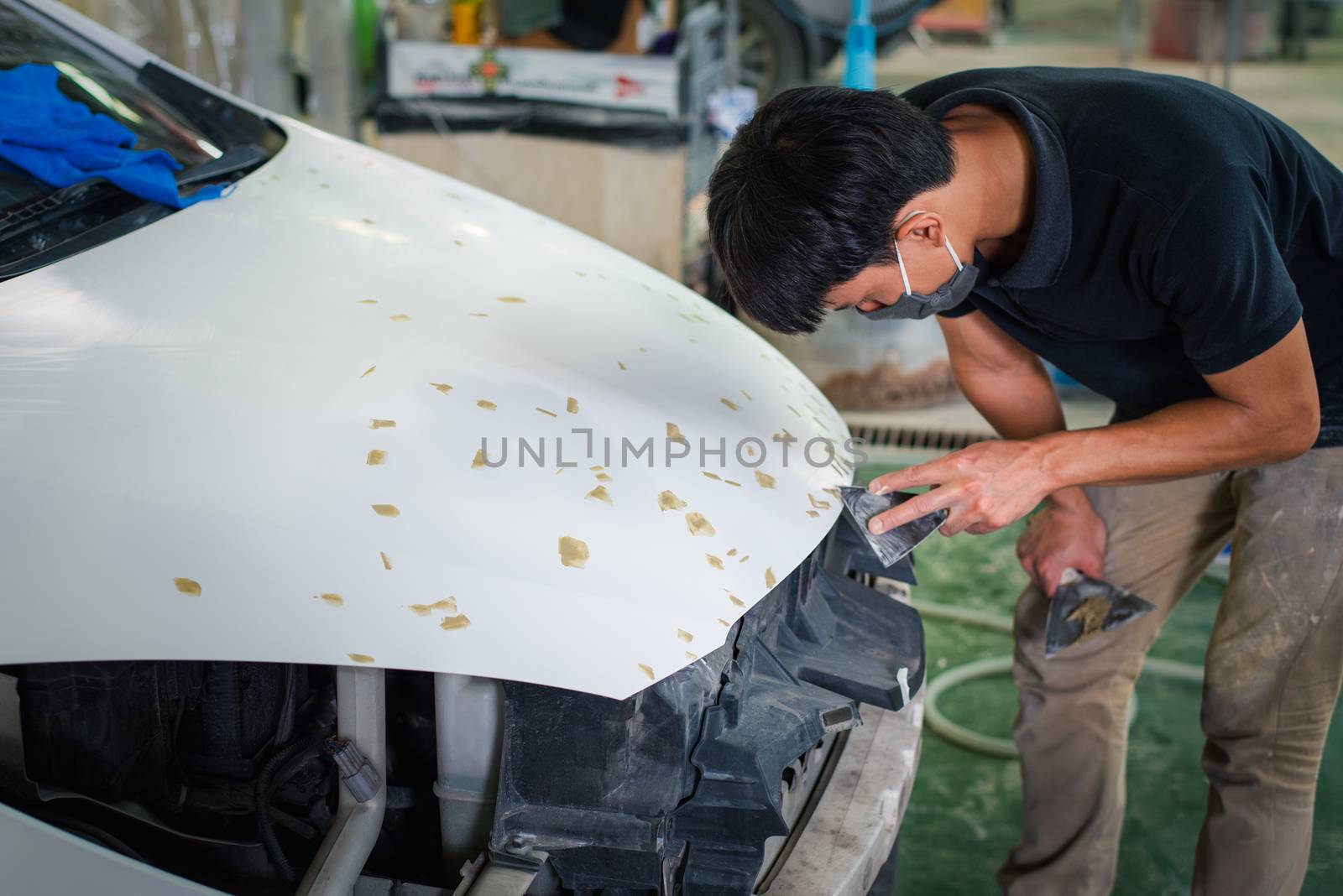 Checking car body work fiber bumper at car garage by PongMoji