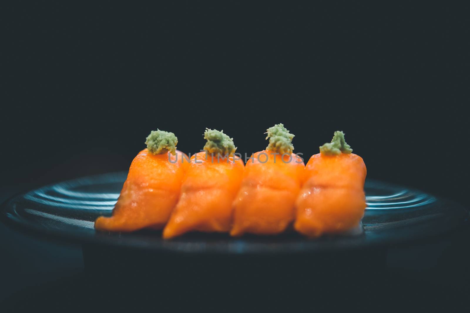 Japanese food in set different types of sushi with seaweed salad and gari (ginger) is a healthy food at the upper right of the serving board in japan restaurant