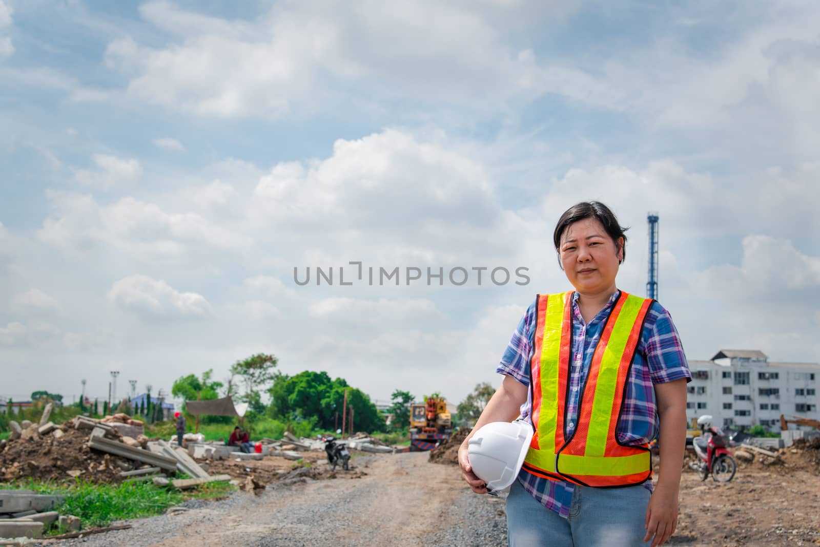 Woman construction engineer at construction site by PongMoji