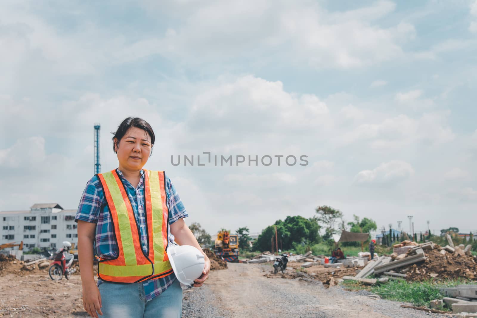 Woman construction engineer at construction site by PongMoji