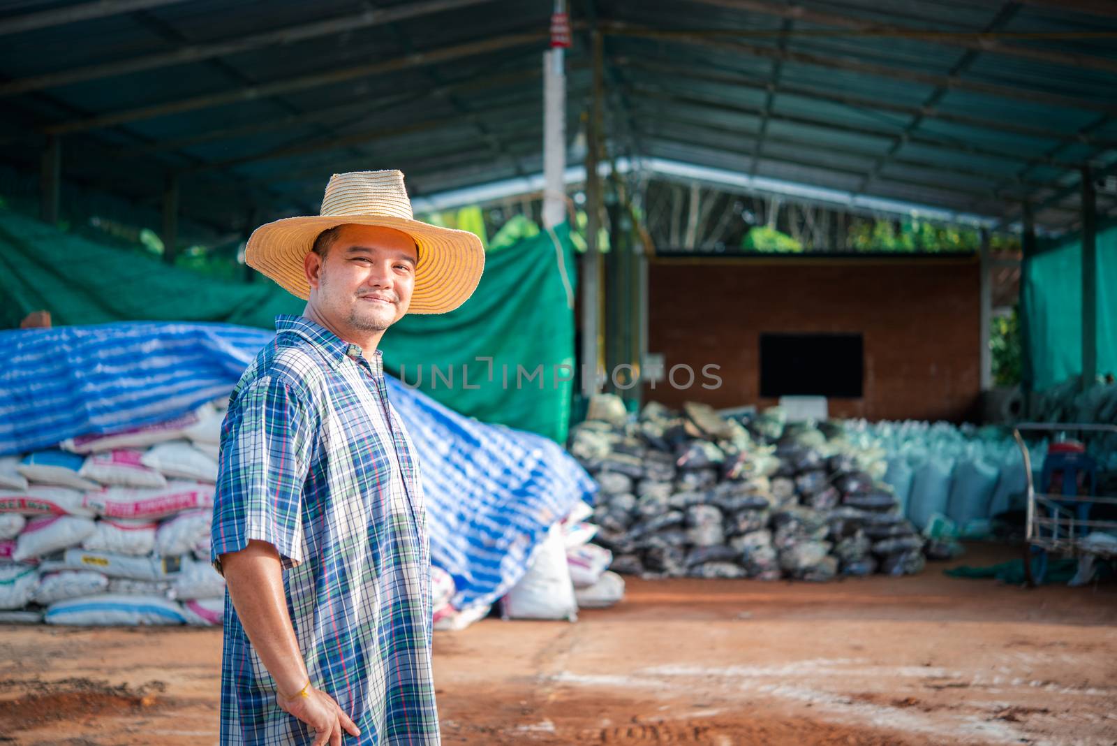Farmer agriculturist with Organic Fertilizer by PongMoji