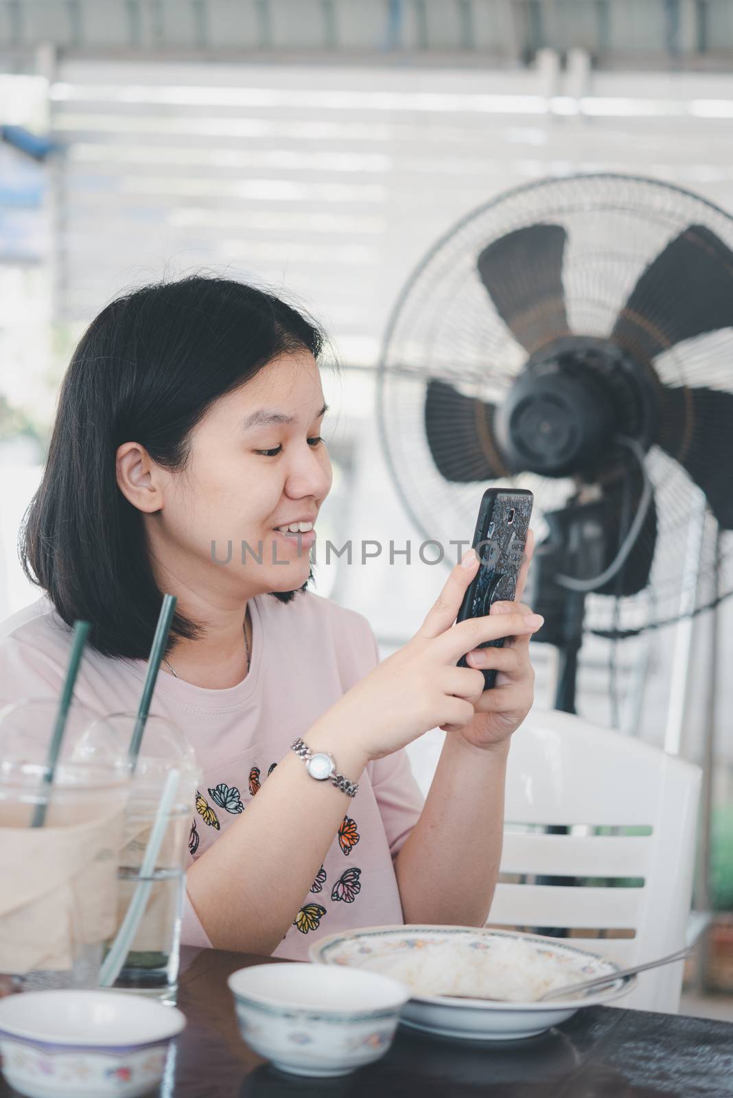 Woman foodstagram photographing a food for share by PongMoji