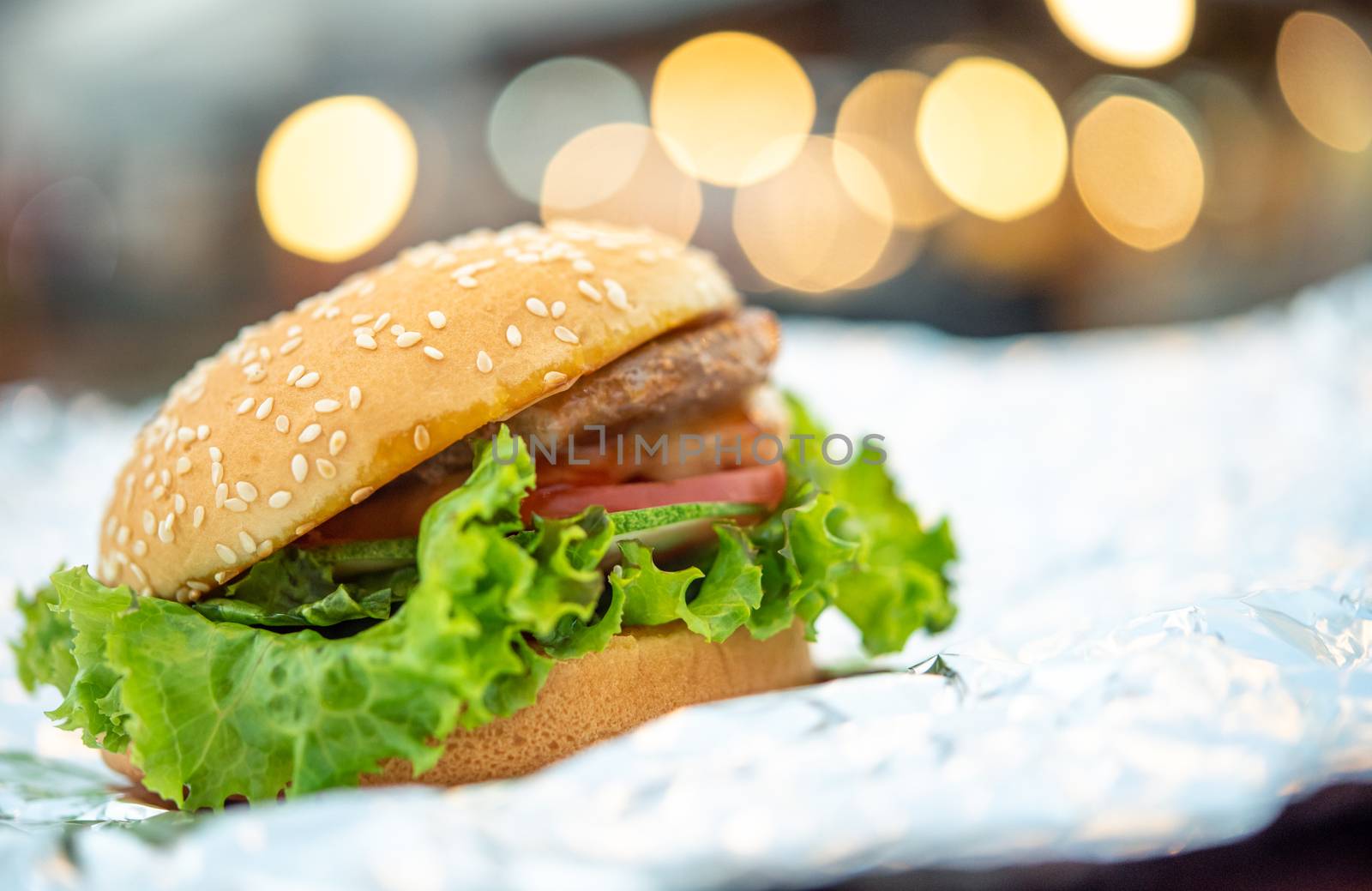 Hamburger is a fast food make from bun, meat, cheese and vegetable  in fastfood restaurant, unhealthy food or fat concept