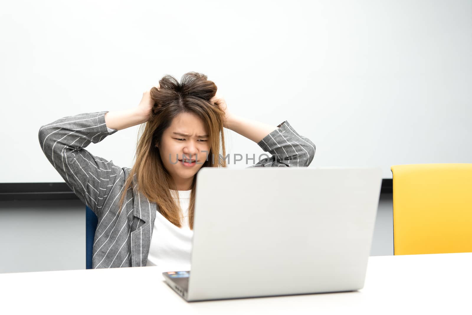 Woman working by laptop in office with annoyed by PongMoji