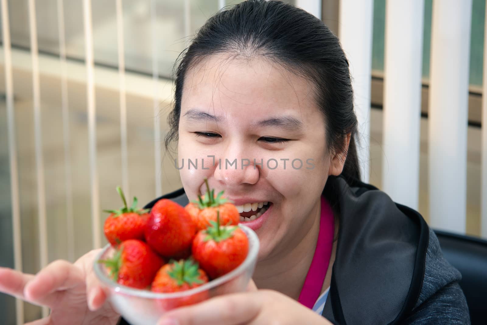 Woman eat strawberry red berry fruit sweet juicy by PongMoji