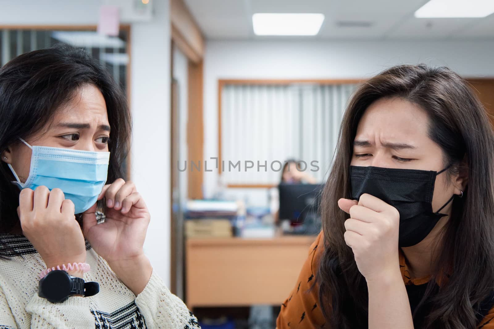 Asian pretty women wearing mask respiratory protection mask against epidemic flu covid19 or corona virus influenza in office with fear emotion in concept illness, outbreak, healthcare in life