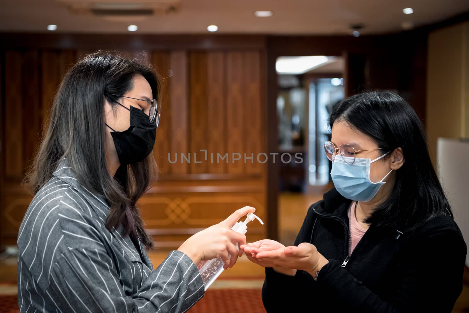 Asian women wearing mask and alcohol antibacterial hand gel respiratory protection mask against epidemic flu covid19 or corona virus with fear emotion in concept illness, outbreak, healthcare in life