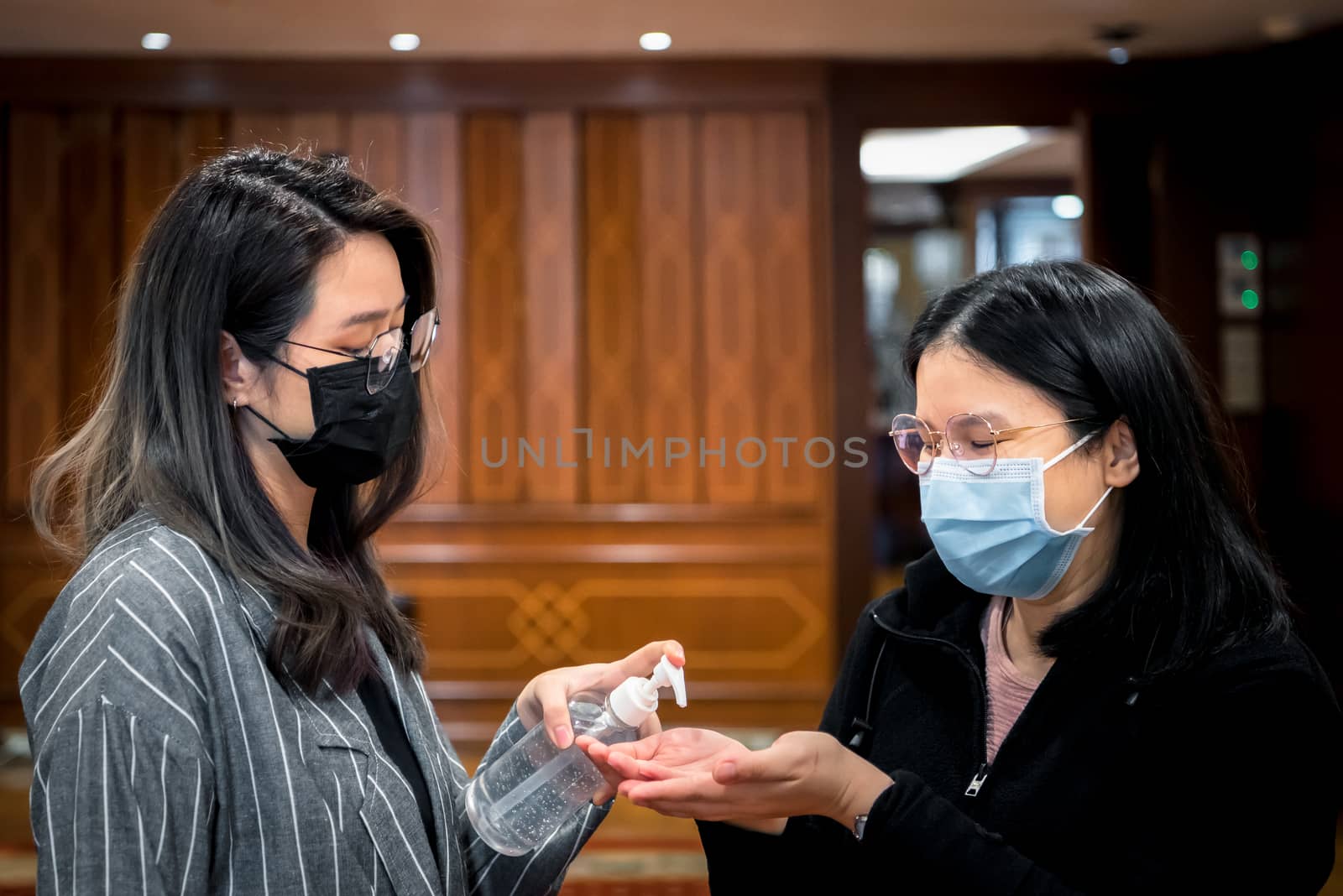 Asian women wearing mask and alcohol antibacterial hand gel respiratory protection mask against epidemic flu covid19 or corona virus with fear emotion in concept illness, outbreak, healthcare in life