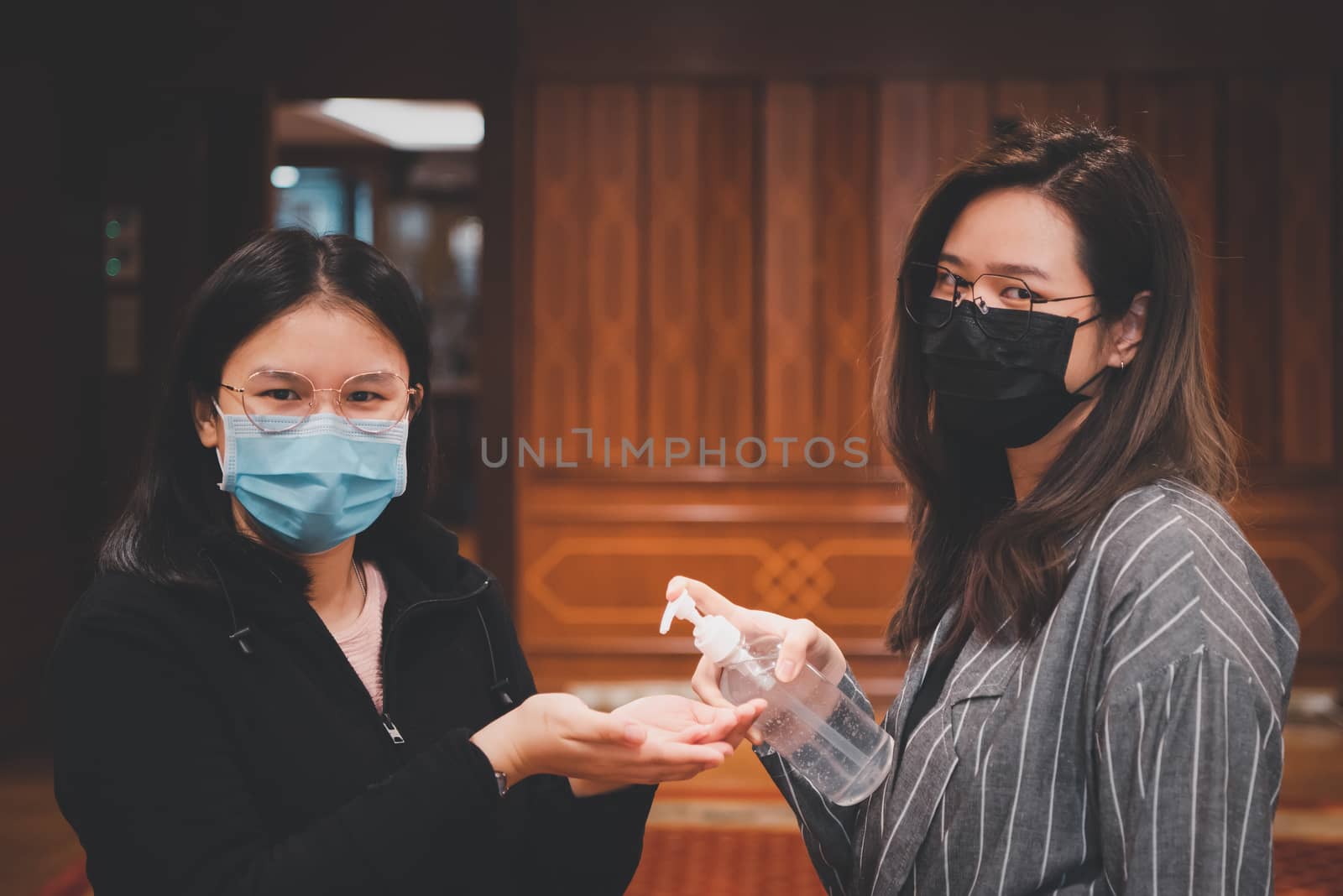 Asian women wearing mask and alcohol antibacterial hand gel respiratory protection mask against epidemic flu covid19 or corona virus with fear emotion in concept illness, outbreak, healthcare in life