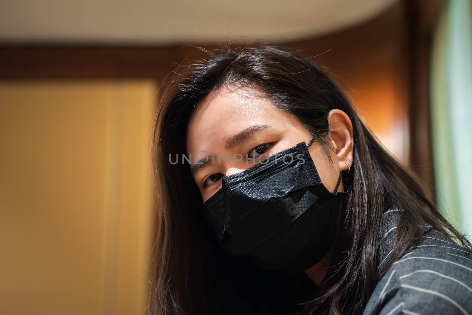 Asian pretty woman wearing mask respiratory protection mask against epidemic flu covid19 or corona virus influenza in office with fear emotion in concept illness, outbreak, healthcare in life