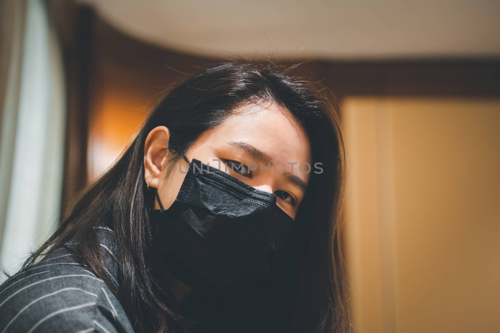 Asian pretty woman wearing mask respiratory protection mask against epidemic flu covid19 or corona virus influenza in office with fear emotion in concept illness, outbreak, healthcare in life