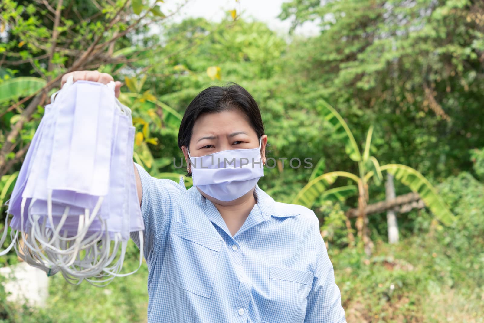 Asian pretty woman wearing mask respiratory protection mask against epidemic flu covid19 or corona virus influenza in office with fear emotion in concept illness, outbreak, healthcare in life