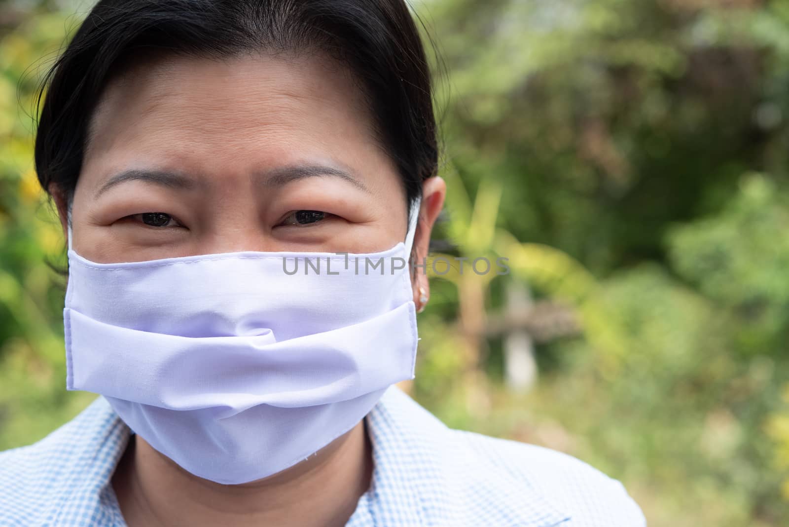 Asian pretty woman wearing mask respiratory protection mask against epidemic flu covid19 or corona virus from wuhan in office with fear emotion in concept illness, outbreak, healthcare in life