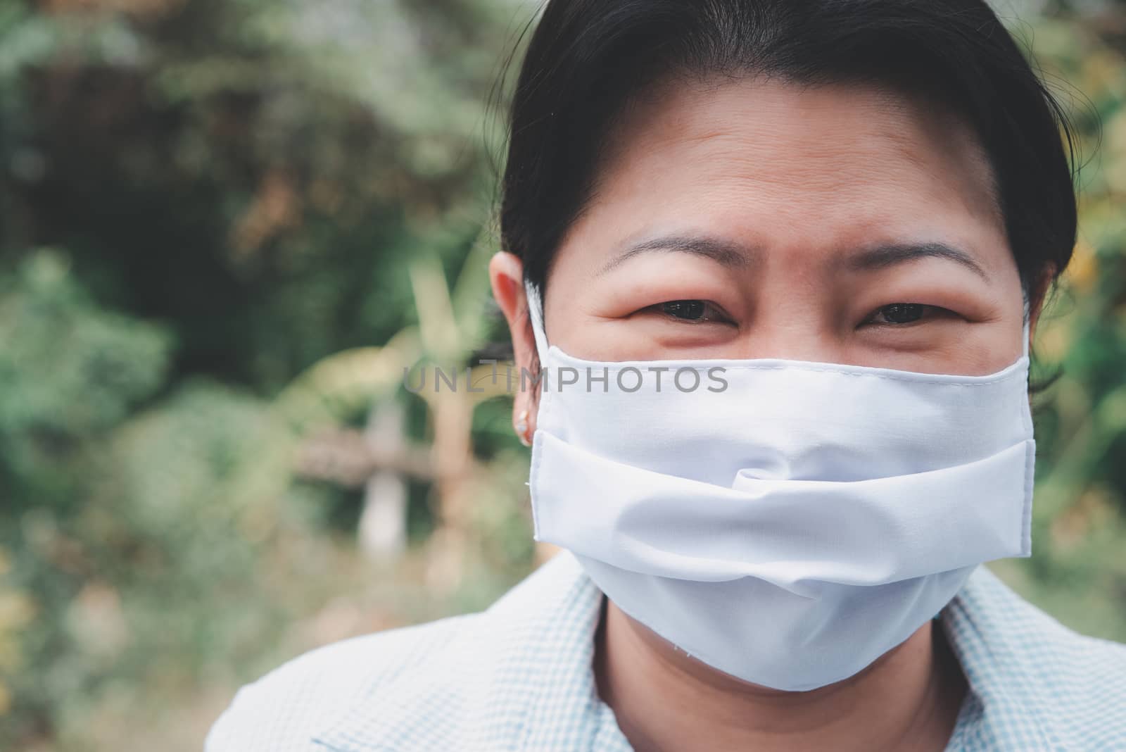 Asian pretty woman wearing mask respiratory protection mask against epidemic flu covid19 or corona virus from wuhan in office with fear emotion in concept illness, outbreak, healthcare in life