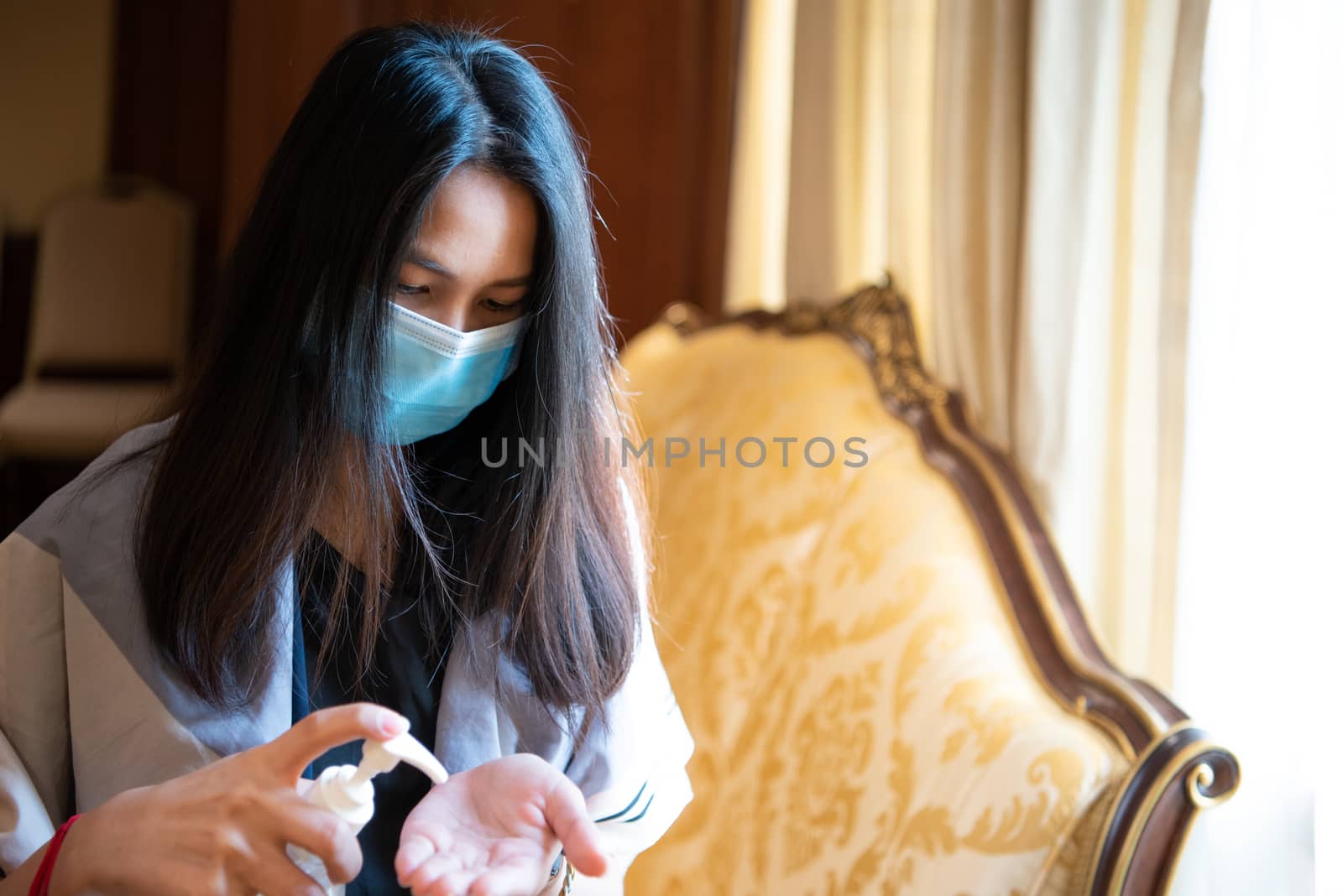 Asian woman wearing mask and alcohol antibacterial hand gel respiratory protection mask against epidemic flu covid19 or corona virus with fear emotion in concept illness, outbreak, healthcare in life