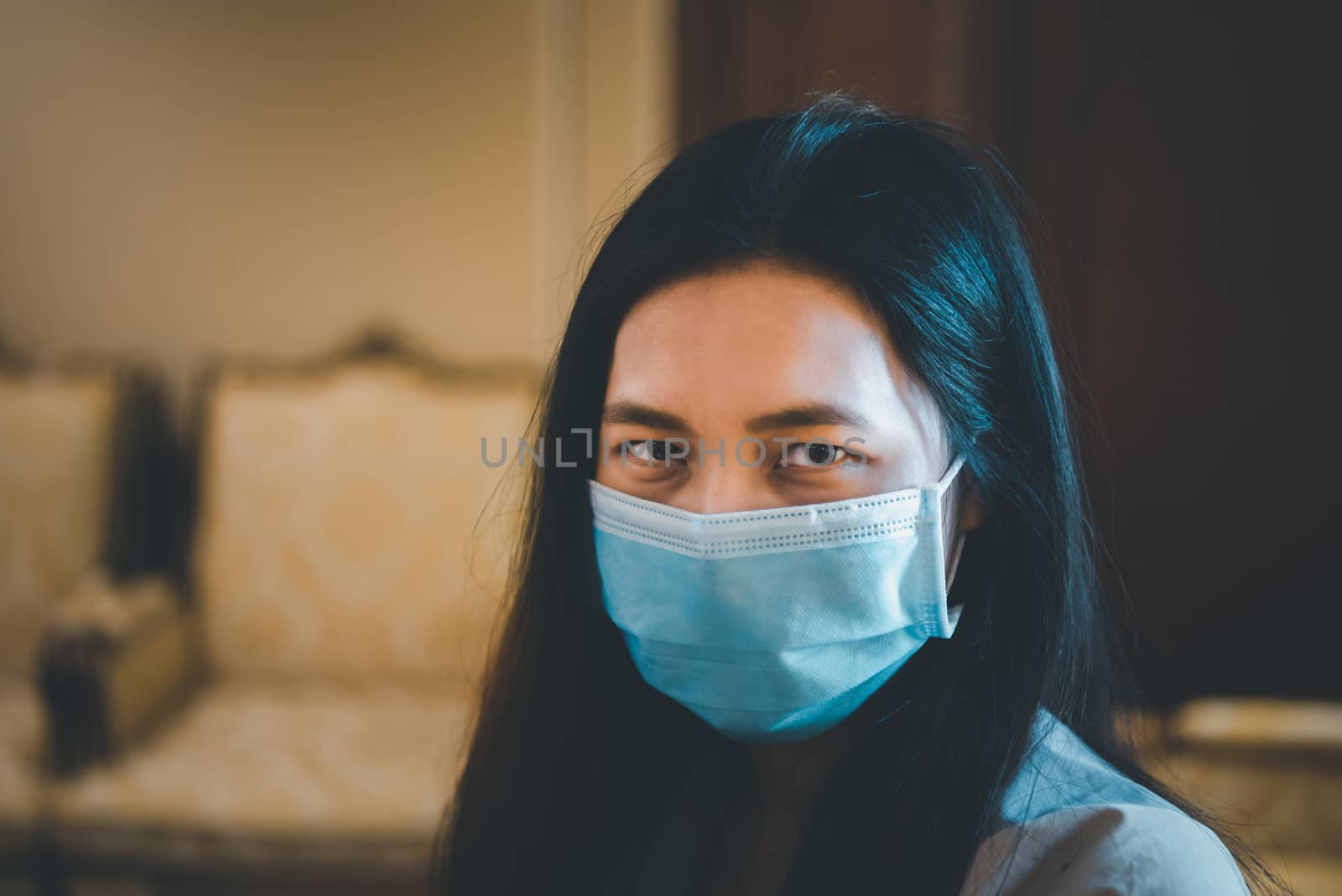 Asian pretty woman wearing mask respiratory protection mask against epidemic flu covid19 or corona virus from wuhan in office with fear emotion in concept illness, outbreak, healthcare in life