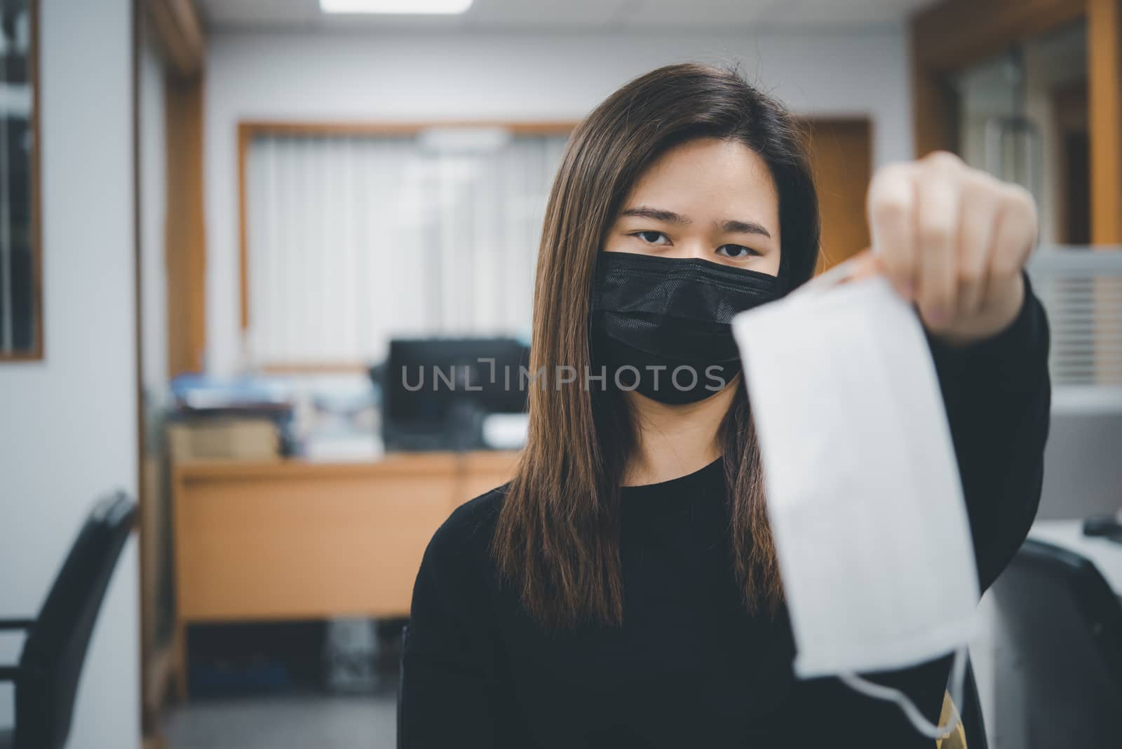 Asian pretty woman wearing mask respiratory protection mask against epidemic flu covid19 or corona virus from wuhan in office with fear emotion in concept illness, outbreak, healthcare in life