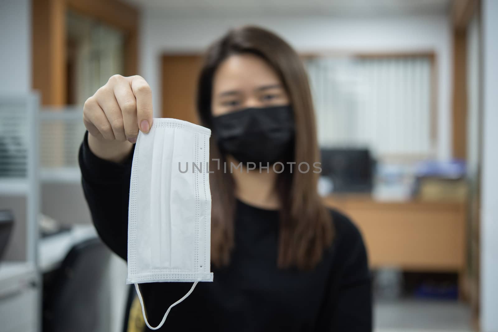 Asian pretty woman wearing mask respiratory protection mask against epidemic flu covid19 or corona virus from wuhan in office with fear emotion in concept illness, outbreak, healthcare in life