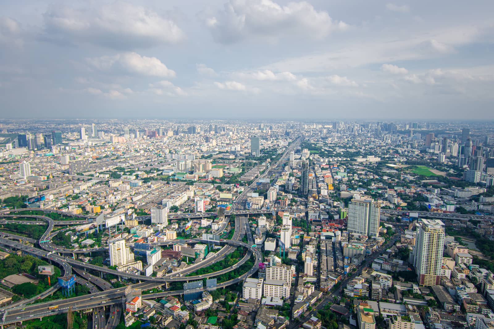 Cityscape and transportation with expressway and traffic in daytime from skyscraper of Bangkok. Bangkok is the capital and the most populous city of Thailand.