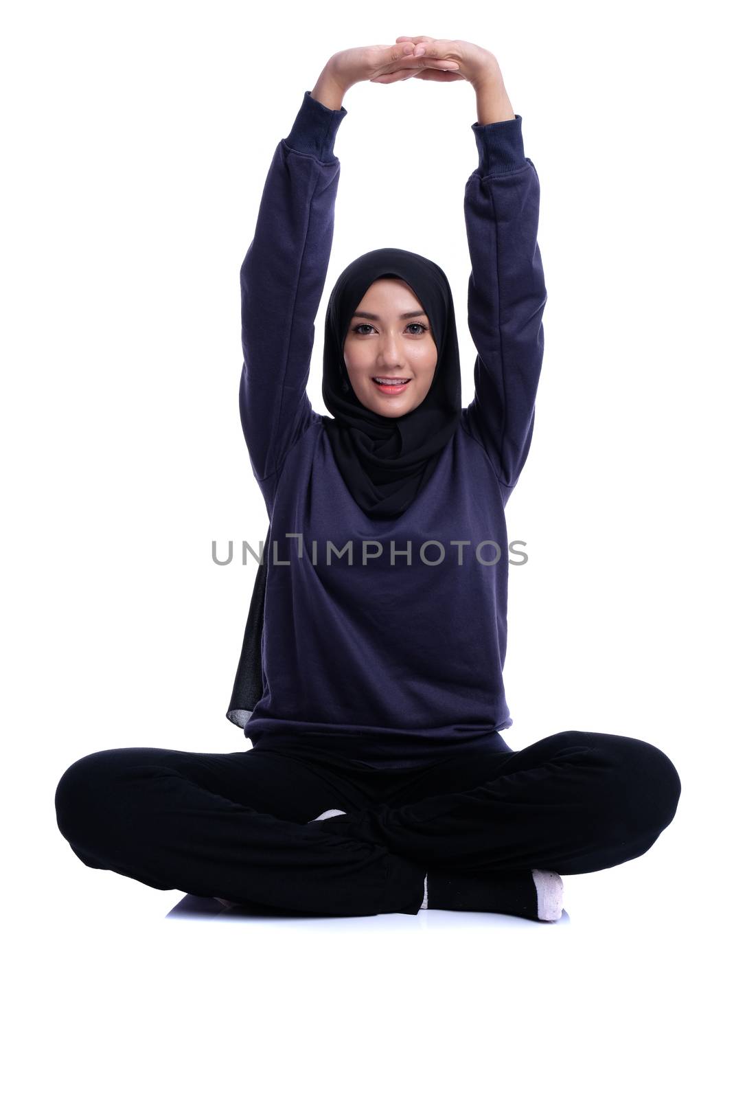 Fitness Muslim Asian girl doing stretch exercise, on white background.