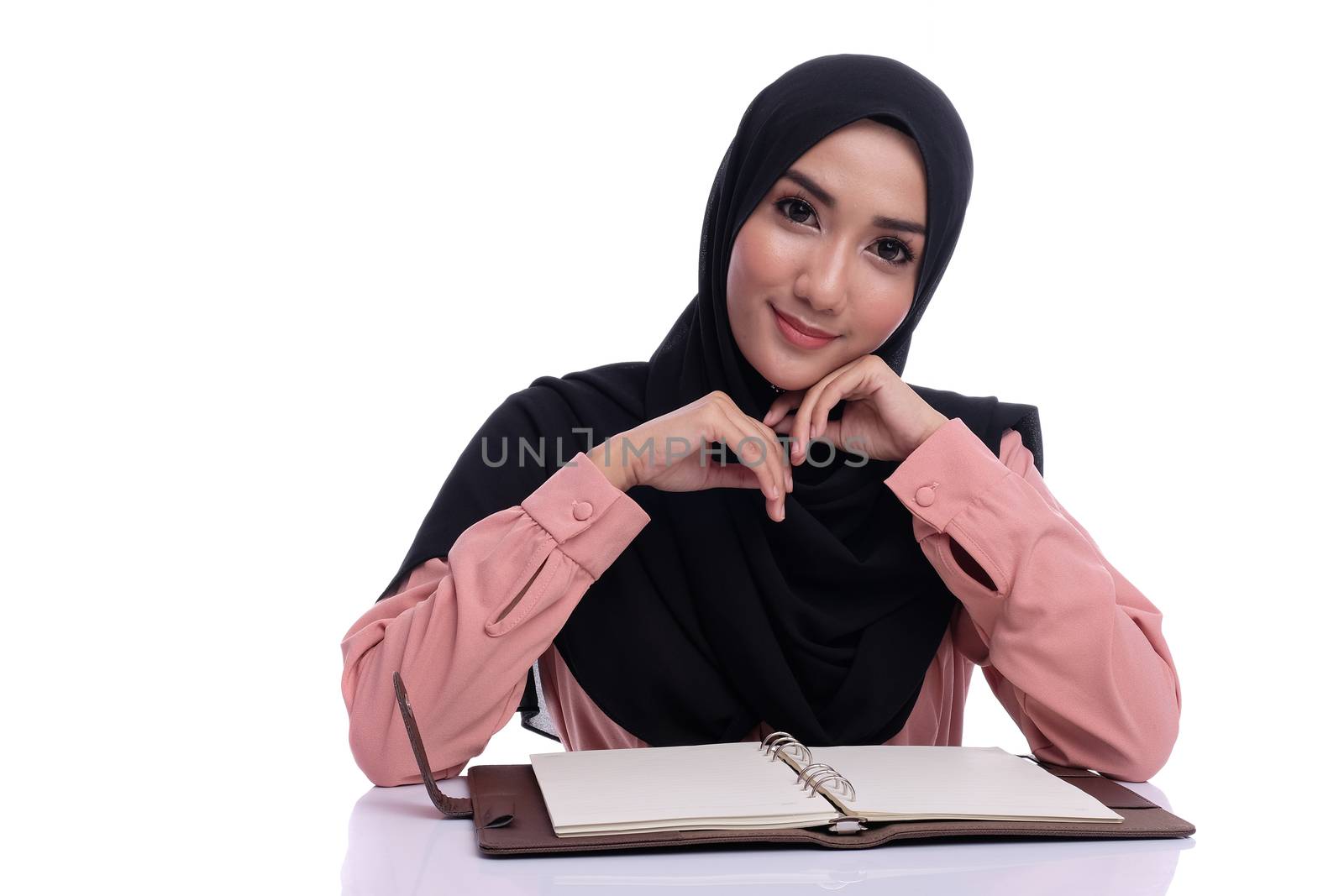 modern asian woman wearing hijab reading a book by alkansari2020