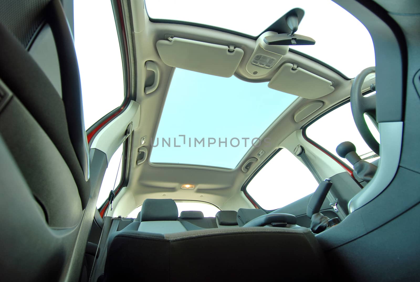 the inside of the car with a semi-open sunroof