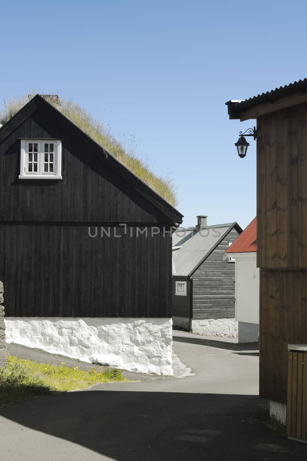 Traditional Black Wood And Stone House With Turf Covered Roof On The Faroe Island