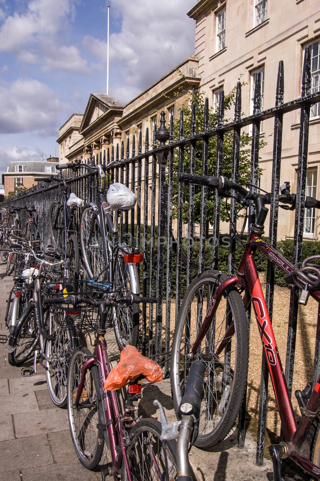 Cambridge, UK - September 19, 2011:  Student bicycles chained to railings outside Emmanuel College on September 19 2011. The City is one of the most bicycle friendly in the country.