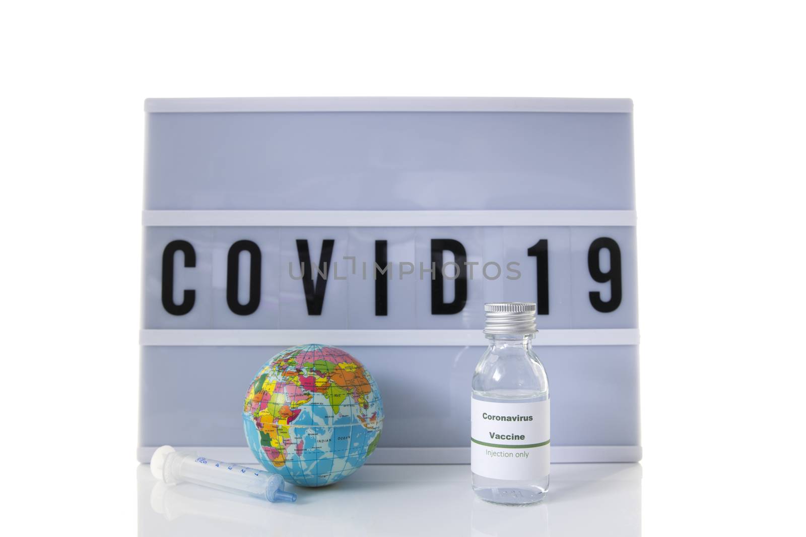 covid 19 on text display wisolated on white background and world globe and vaccine