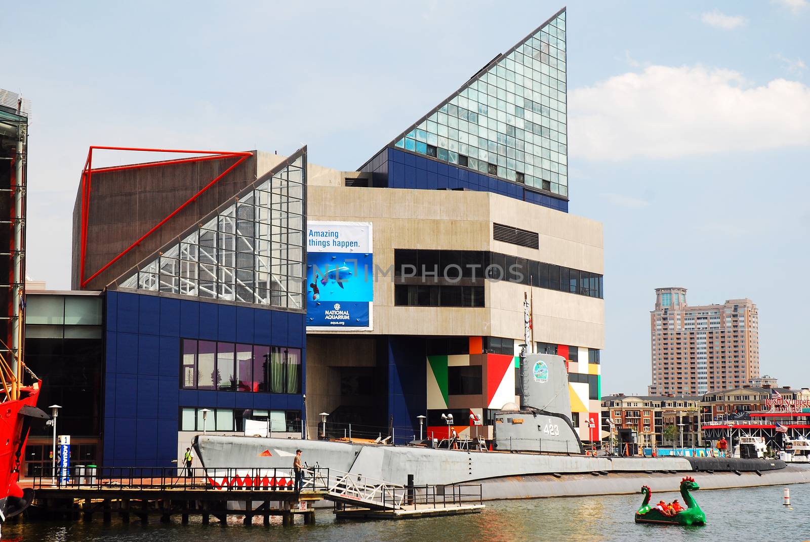 The stark geometric lines of the National Aquarium in Baltimore stand out in the Inner Harbor area