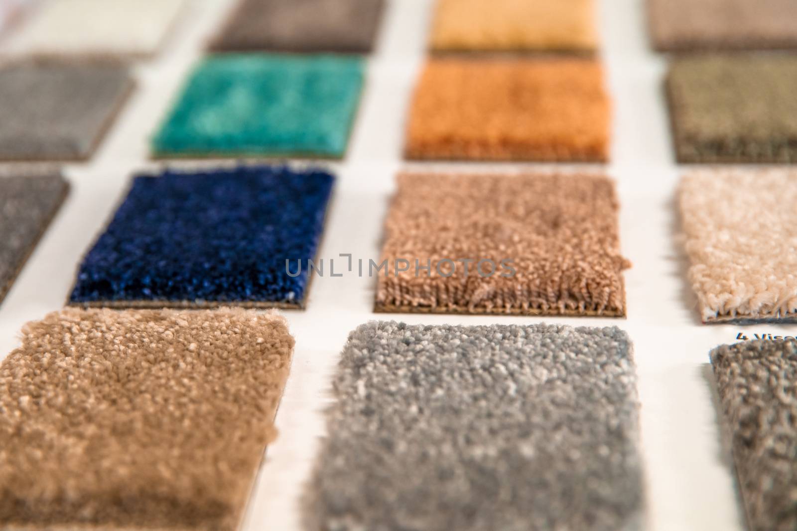 sample of colored carpets in floor shop by Edophoto