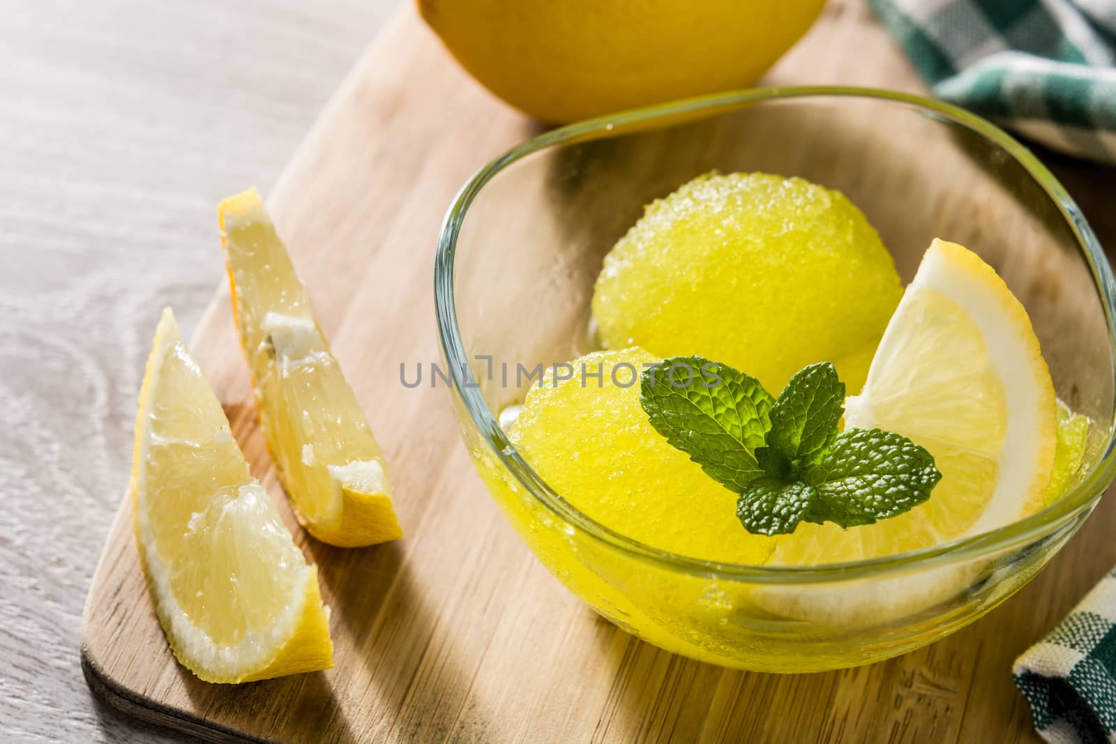 Lemon sorbet in glasses on white wooden background