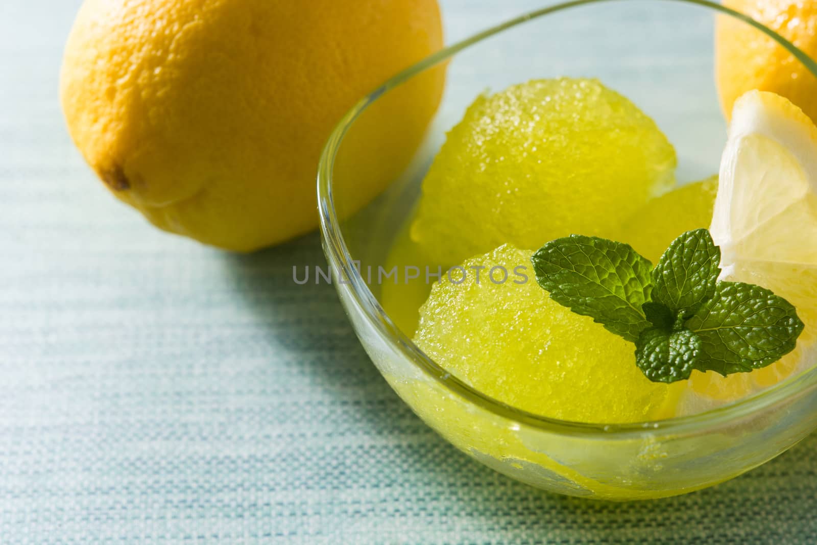 Lemon sorbet in glasses on blue background