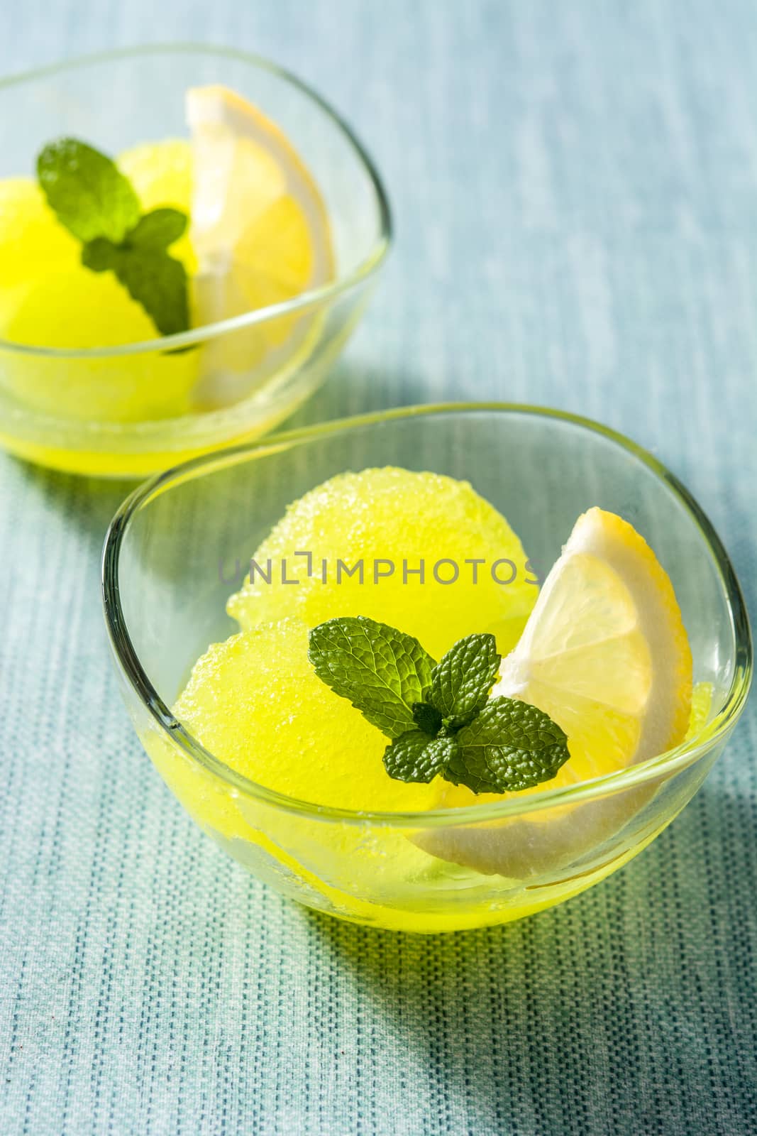 Lemon sorbet in glasses on blue background