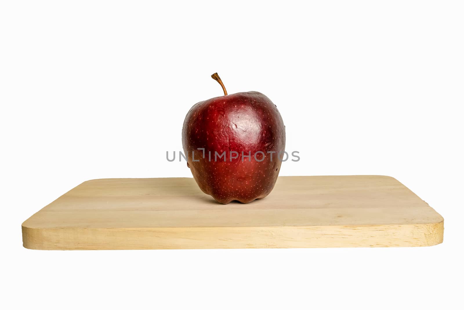 Apple fruit placed on a wooden tray in a white background