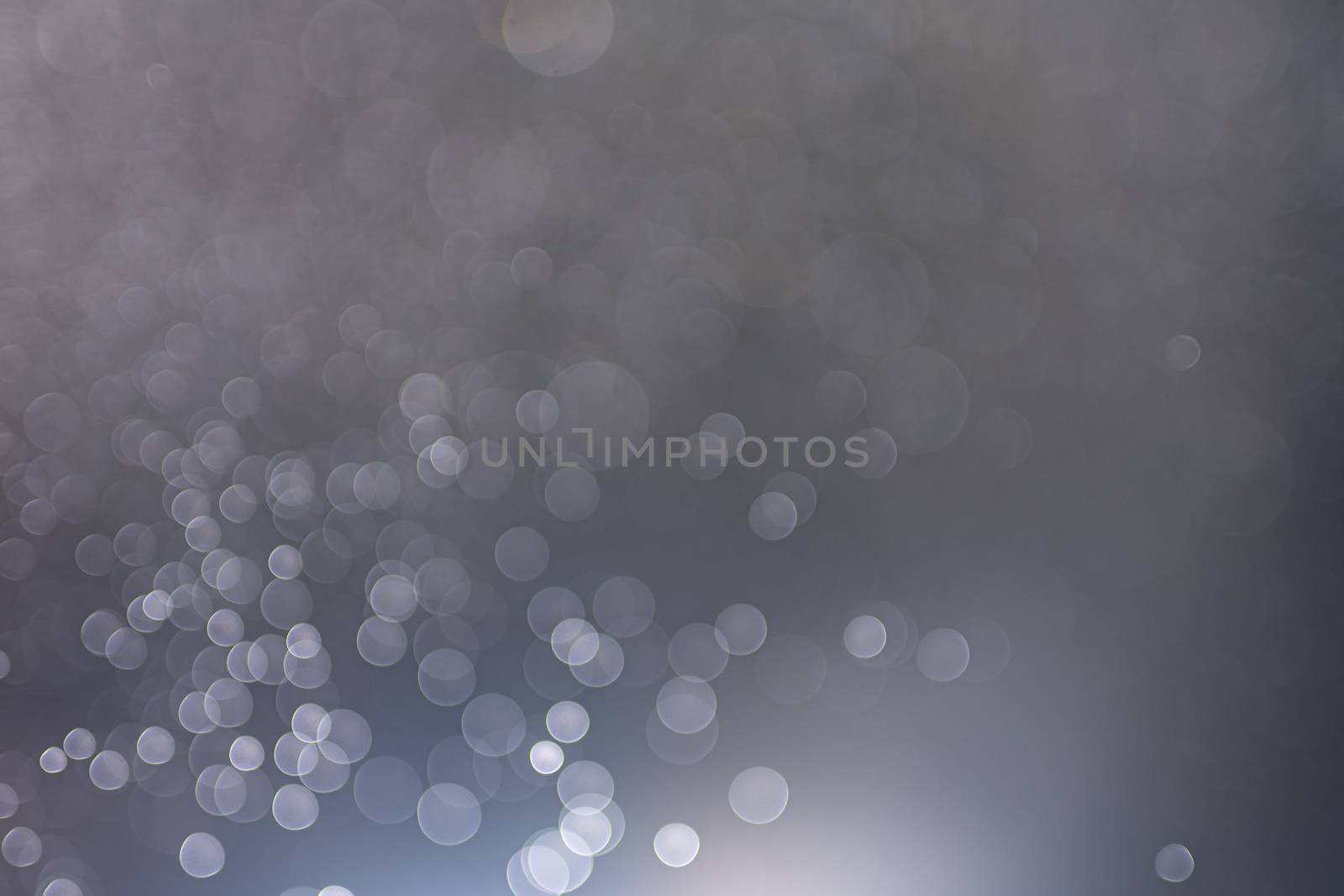 Abstract bokeh from light and water spray in backgrounds of various colors