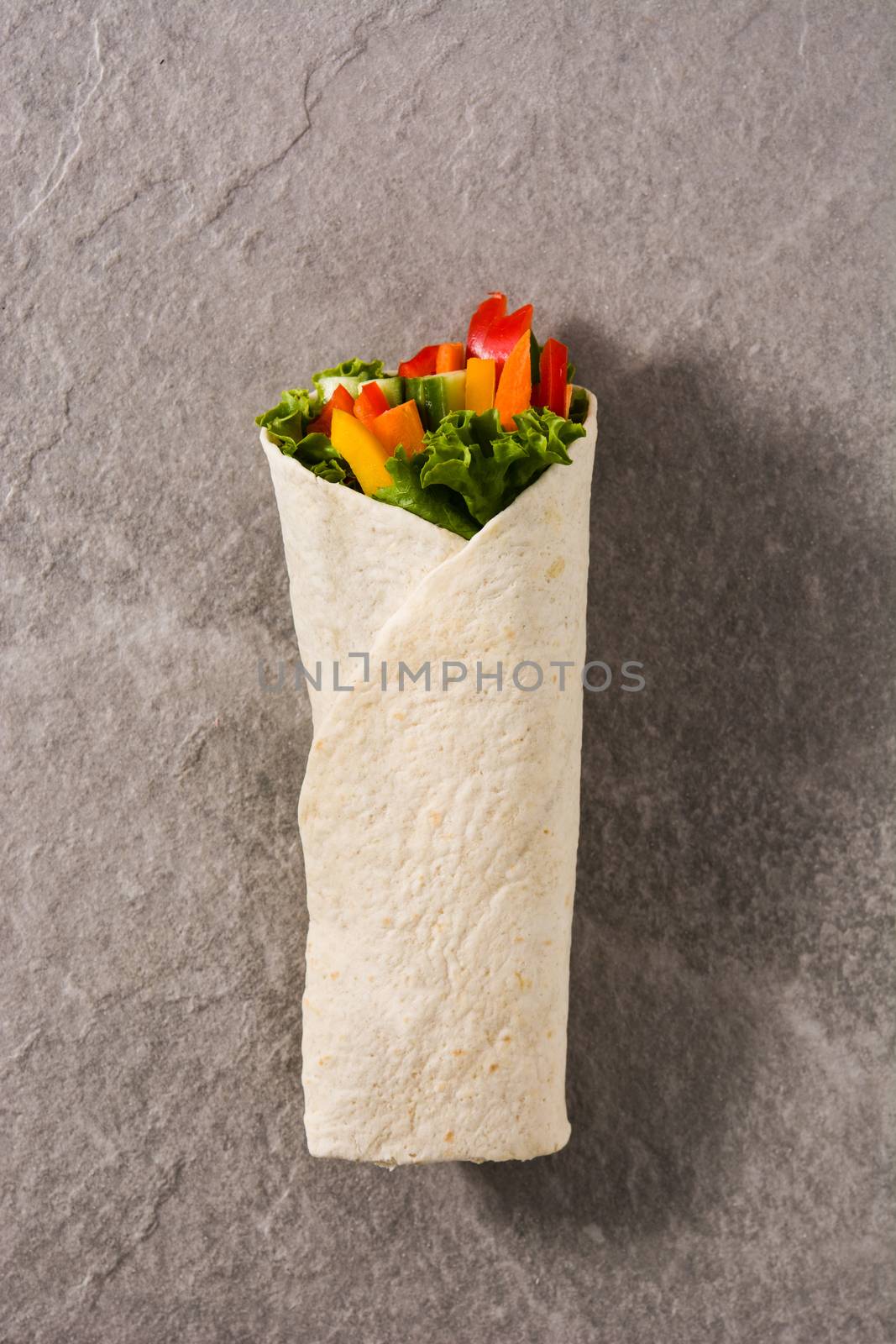 Vegetable tortilla wraps on gray background