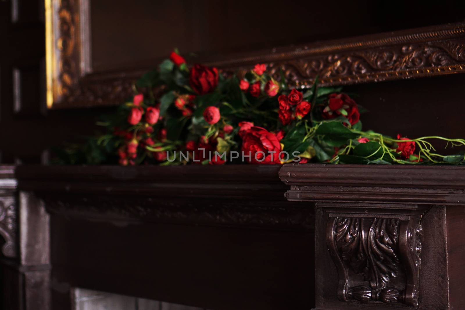A fake flowers arrangement on a fireplace mantel by natali_brill