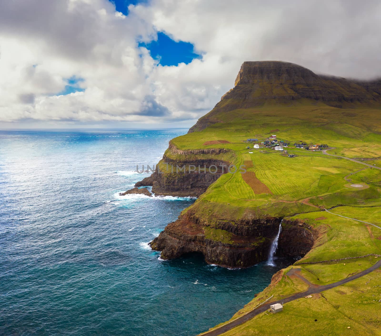 Aerial view of Gasadalur village and its waterfall in Faroe Islands, Denmark by nickfox