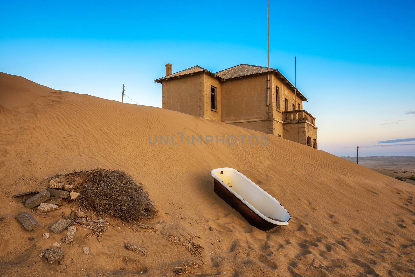 Empty bathtub placed outside in the sand desert around the ghost town of Kolmanskop.