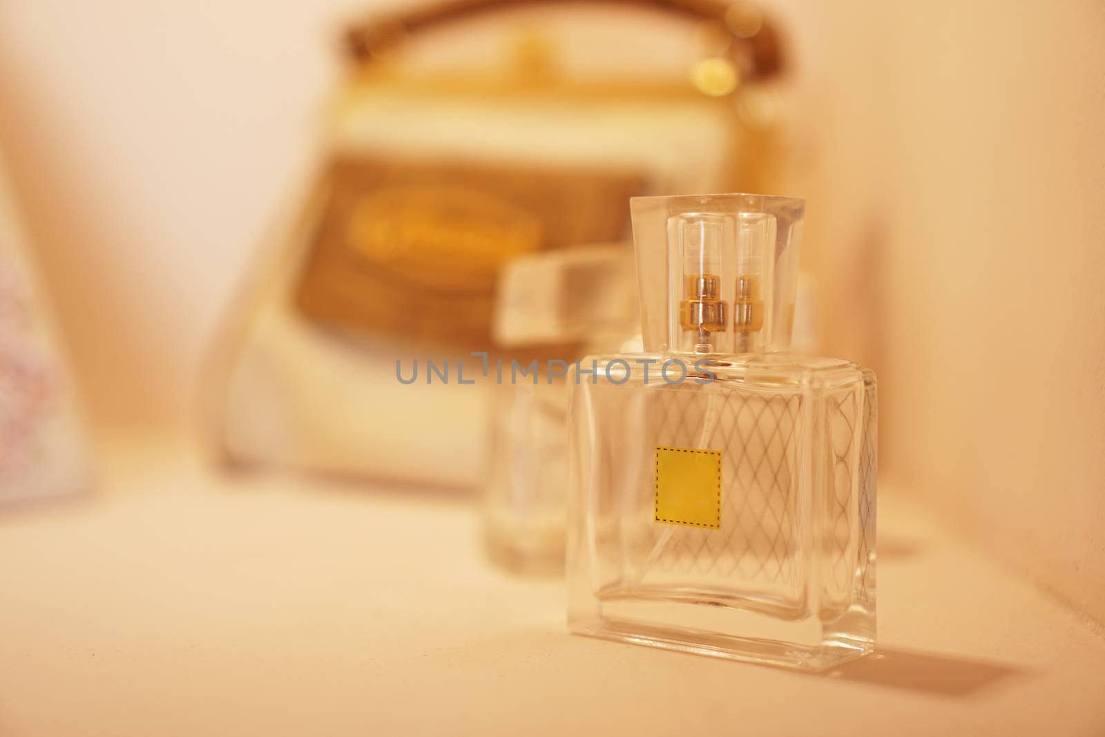 Bottle gift toilet water perfume on a background of blurred lights. by natali_brill