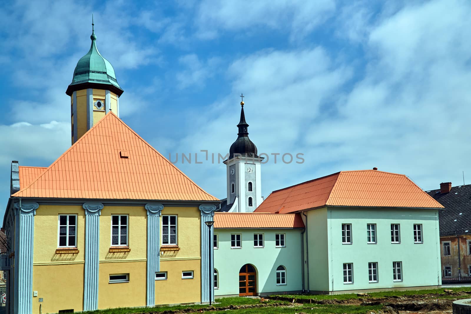 A historic tenement house and a belfry  in the city of Javornik in the Czech Republic